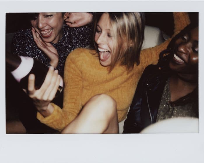 A blurred snapshot of friends celebrating, sealed until later