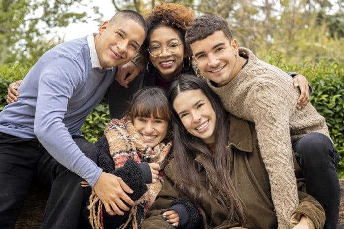 A group of friends embracing in a park